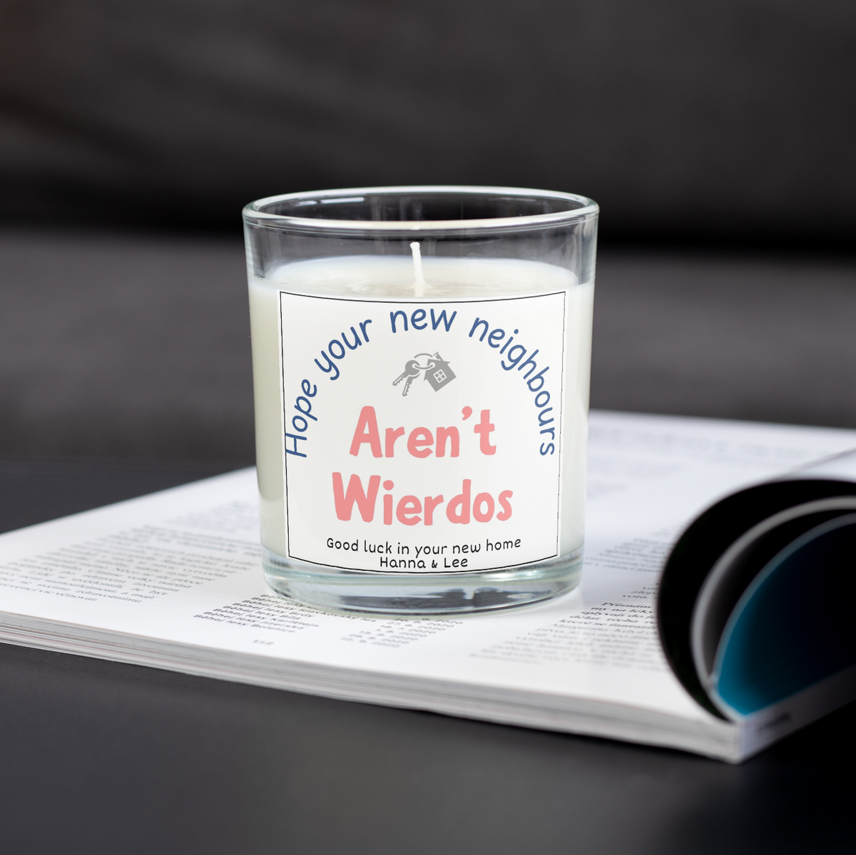 Funny personalised new home candle about weird neighbours on an open magazine