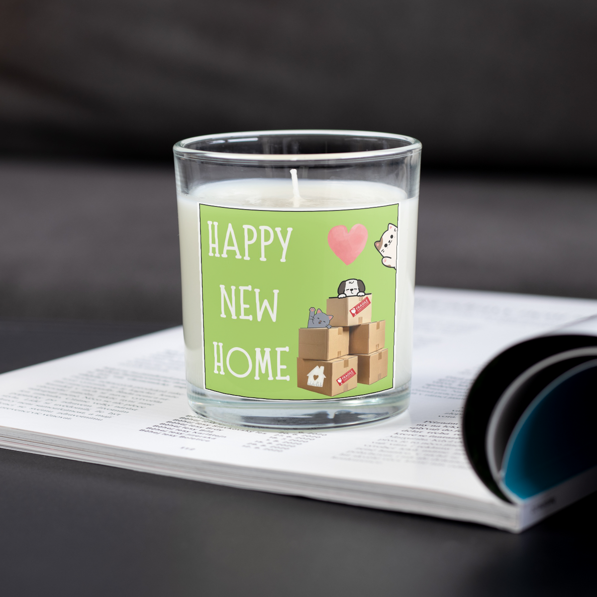 Happy New Home candle with moving boxes design on an open magazine