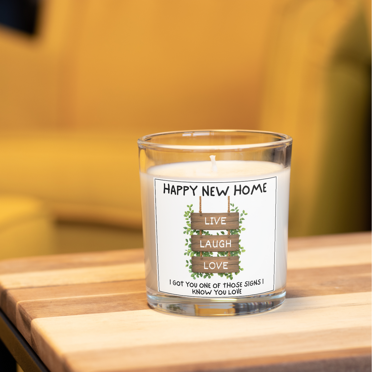 Happy New Home Live Laugh Love candle in a home setting