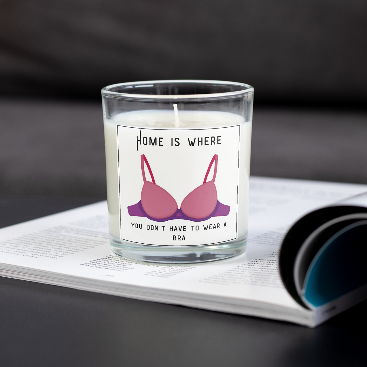 Home Is Where You Don't Have to Wear a Bra candle on an open magazine