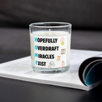 Hopefully Overdraft Miracles Exist housewarming candle on an open magazine
