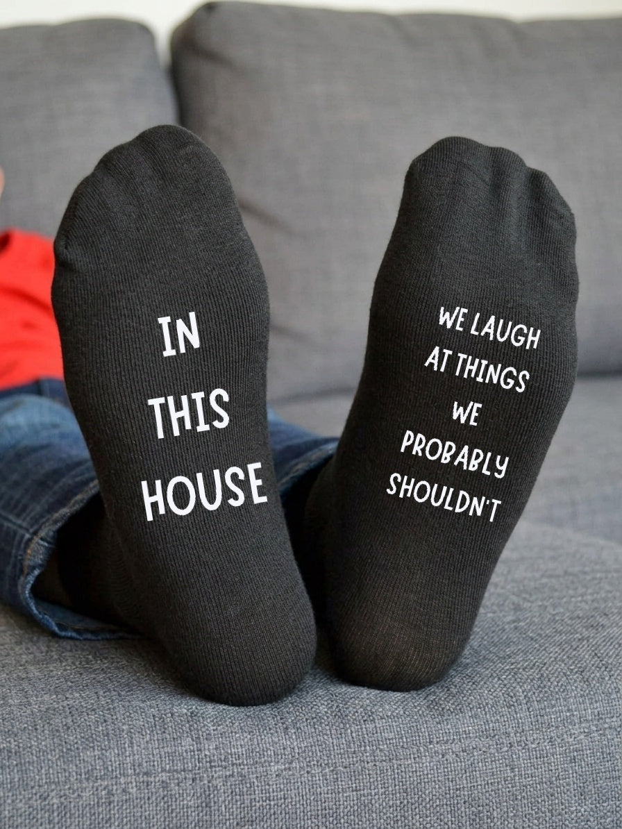 In This House We Laugh at Things Socks – Funny Gift – sofa lifestyle view