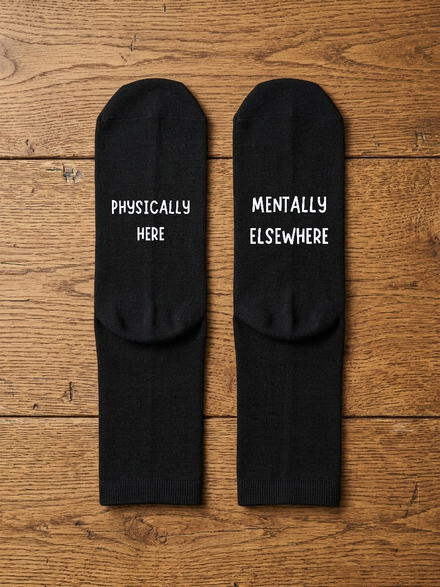 Physically Here Mentally Elsewhere Socks – Funny Gift – flat lay